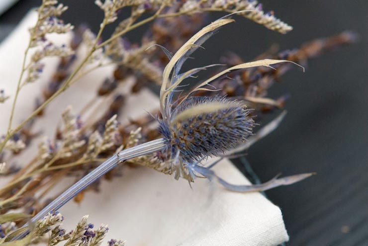 A closeup of thistle and lavender tied to a napkin.