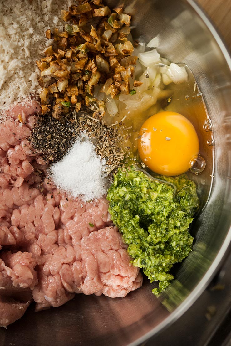 A large mixing bowl of meatball ingredients.