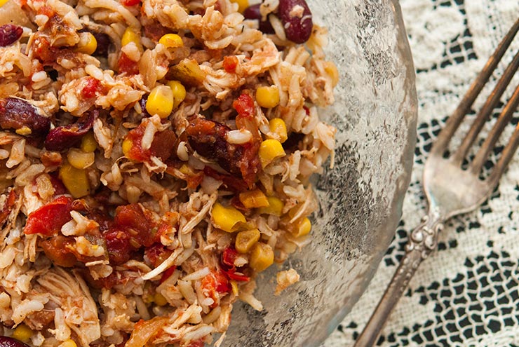 A bowl of Santa Fe Chicken on a lace table cloth.