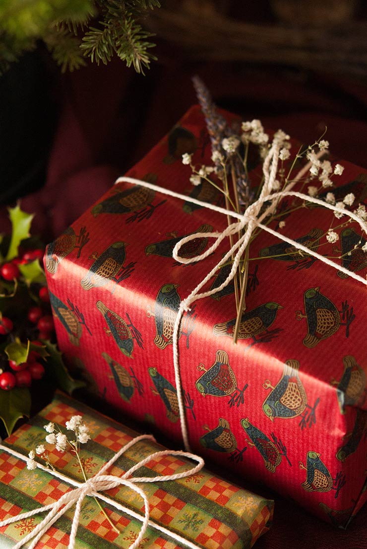 Presents wrapped with string and flowers.