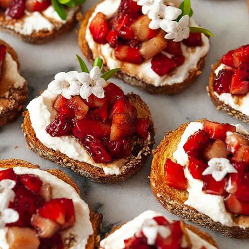 9 strawberry crostini on marble.