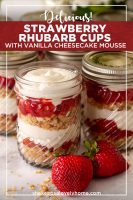 Strawberry rhubarb cups with vanilla cheesecake mouse on a marble table with a few strawberries beside them.