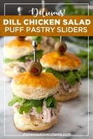 Chicken salad sliders on a marble board surrounded by arugula (Pinterest image).