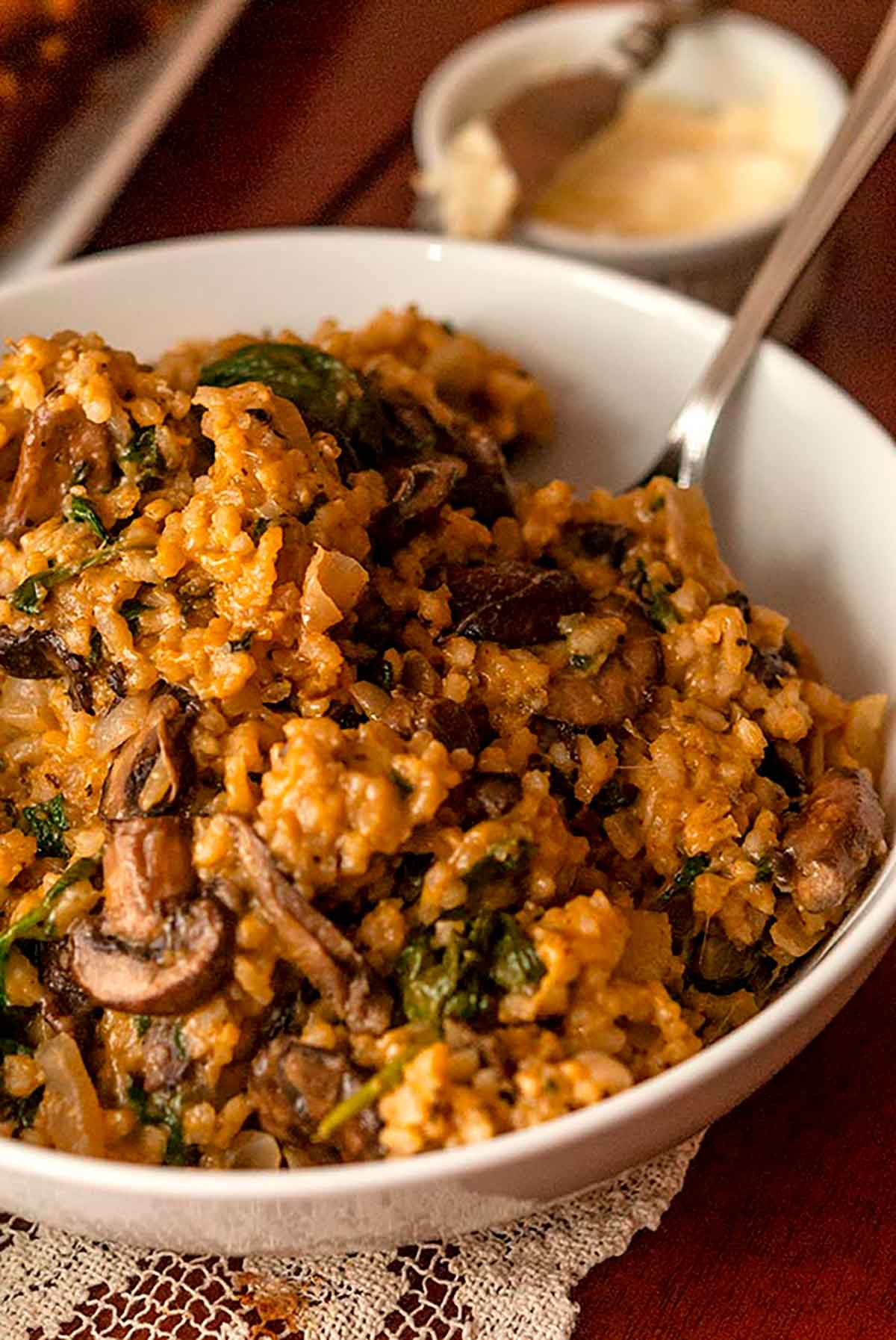 A large bowl of risotto with a serving spoon.