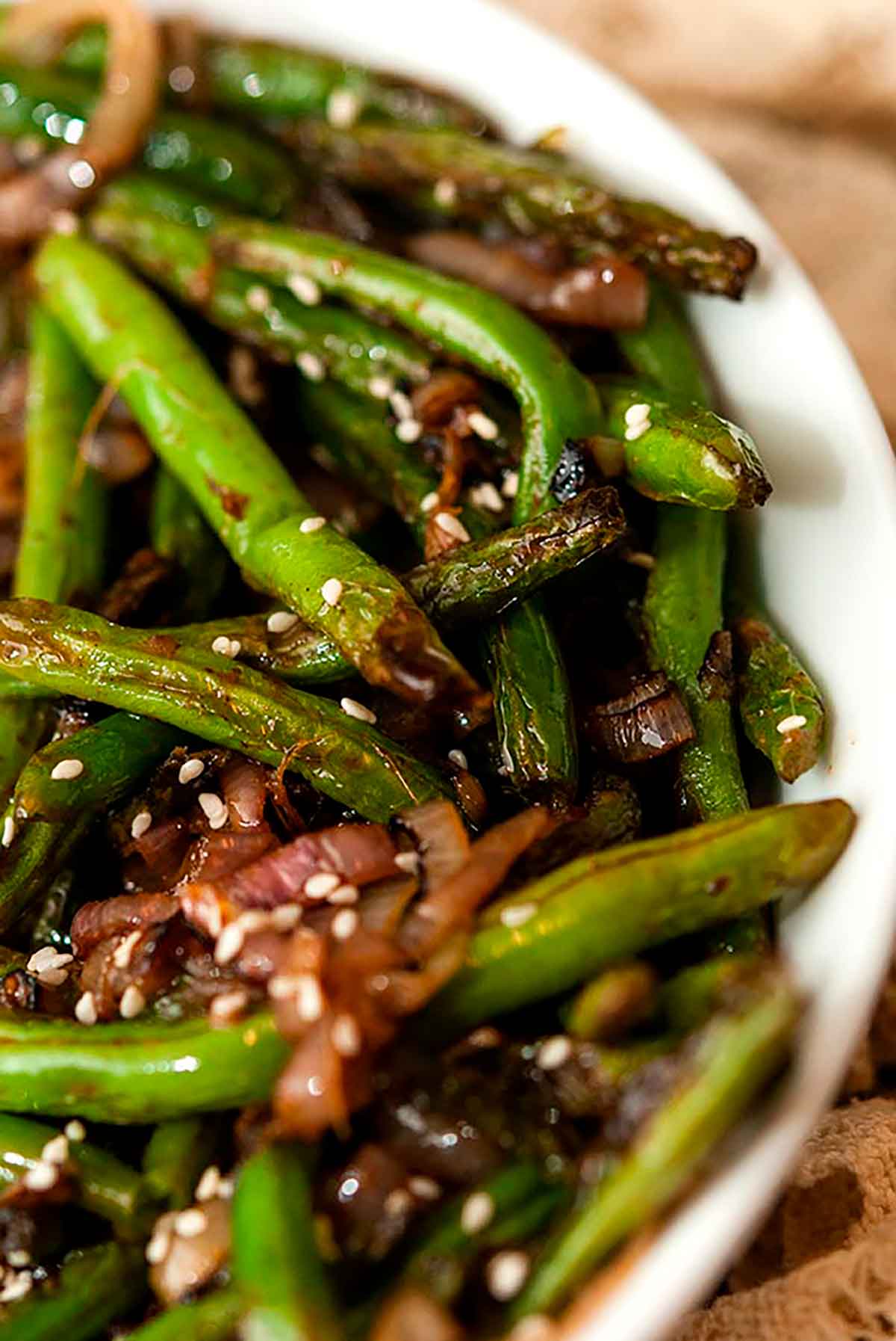 A bowl of blistered French green beens and shallots.