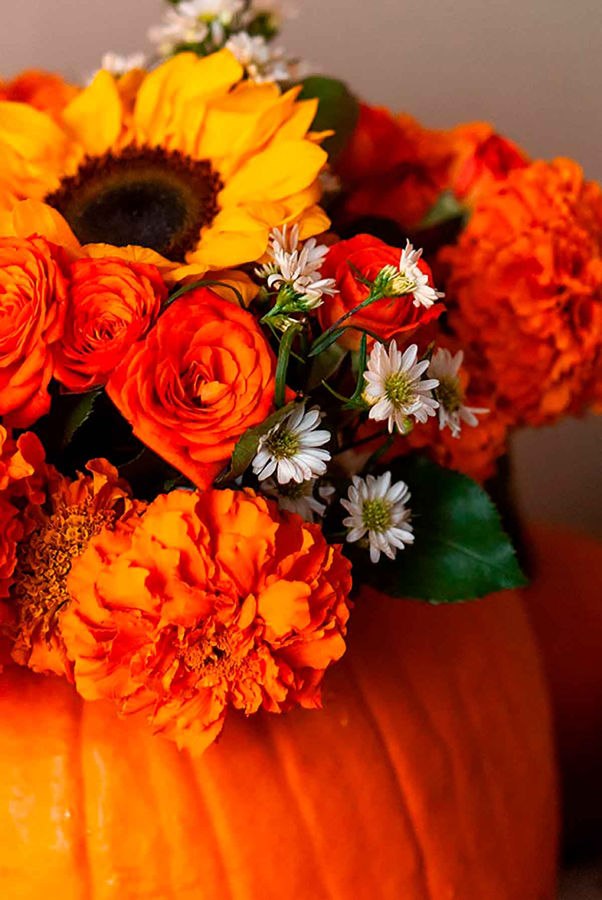 A bouquet of Autumn flowers in a pumpkin.