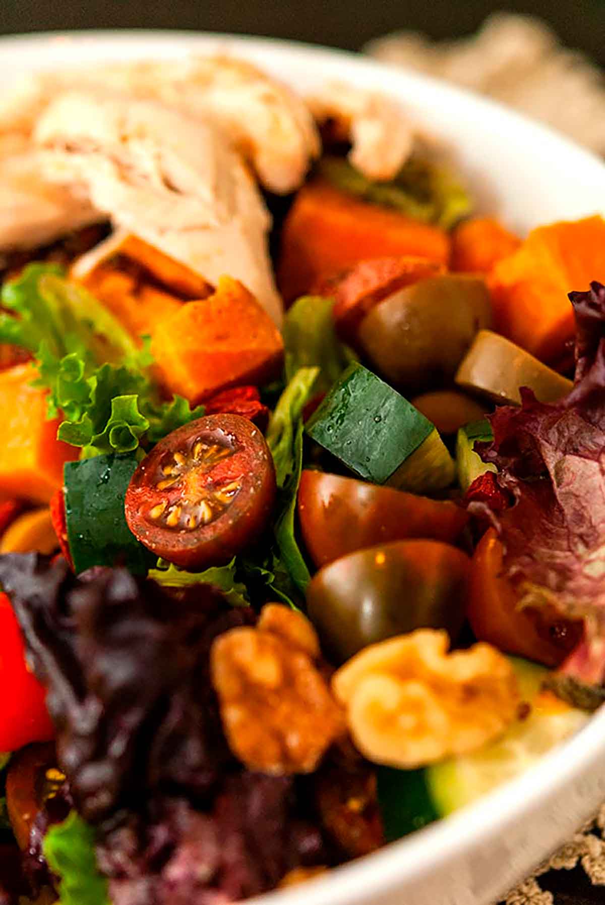 A colorful salad with many assorted vegetables.