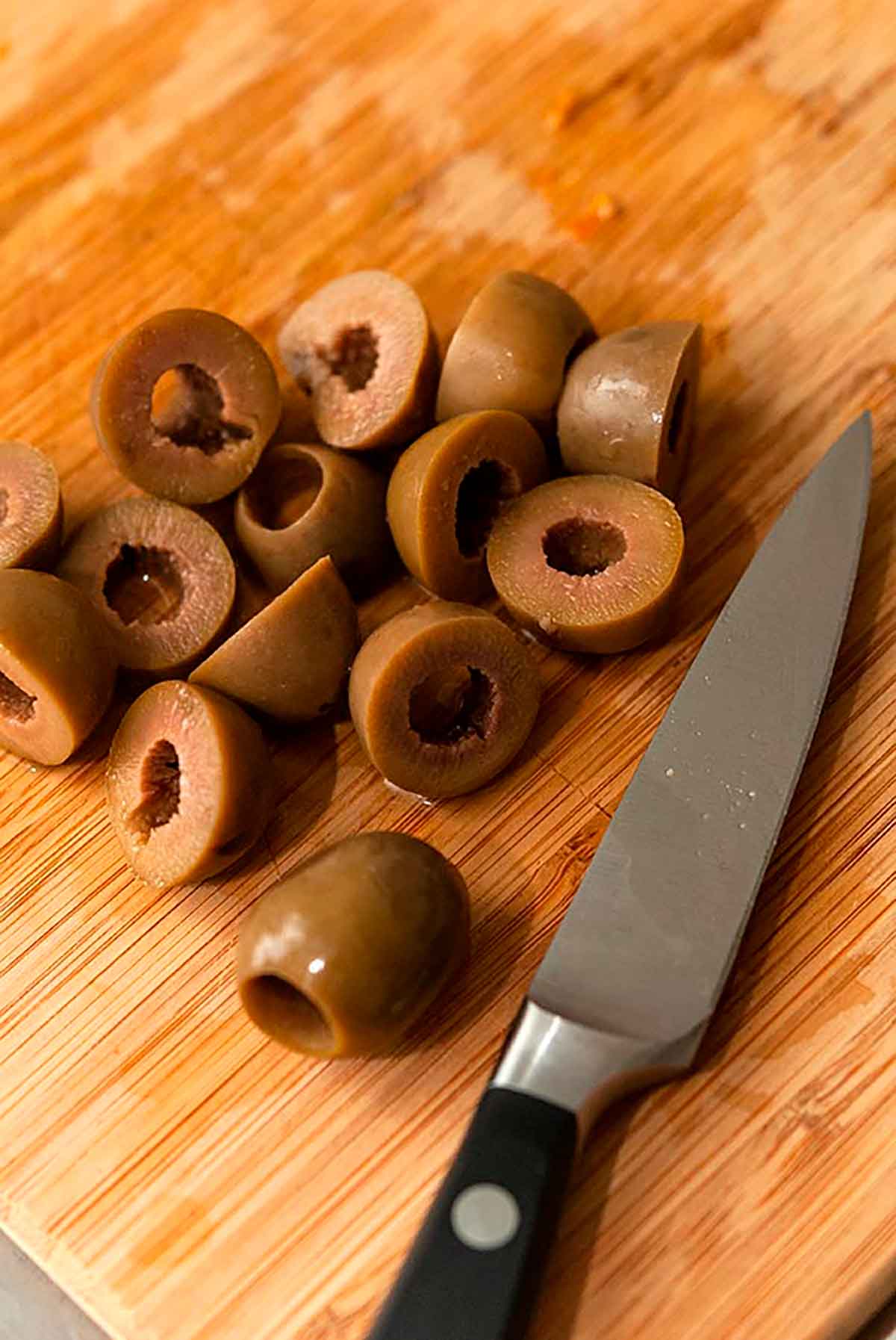 Sliced olives on a cutting board.