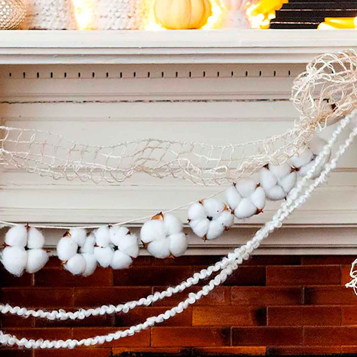 Cotton garland strung on a mantle with yarn and ribbon.