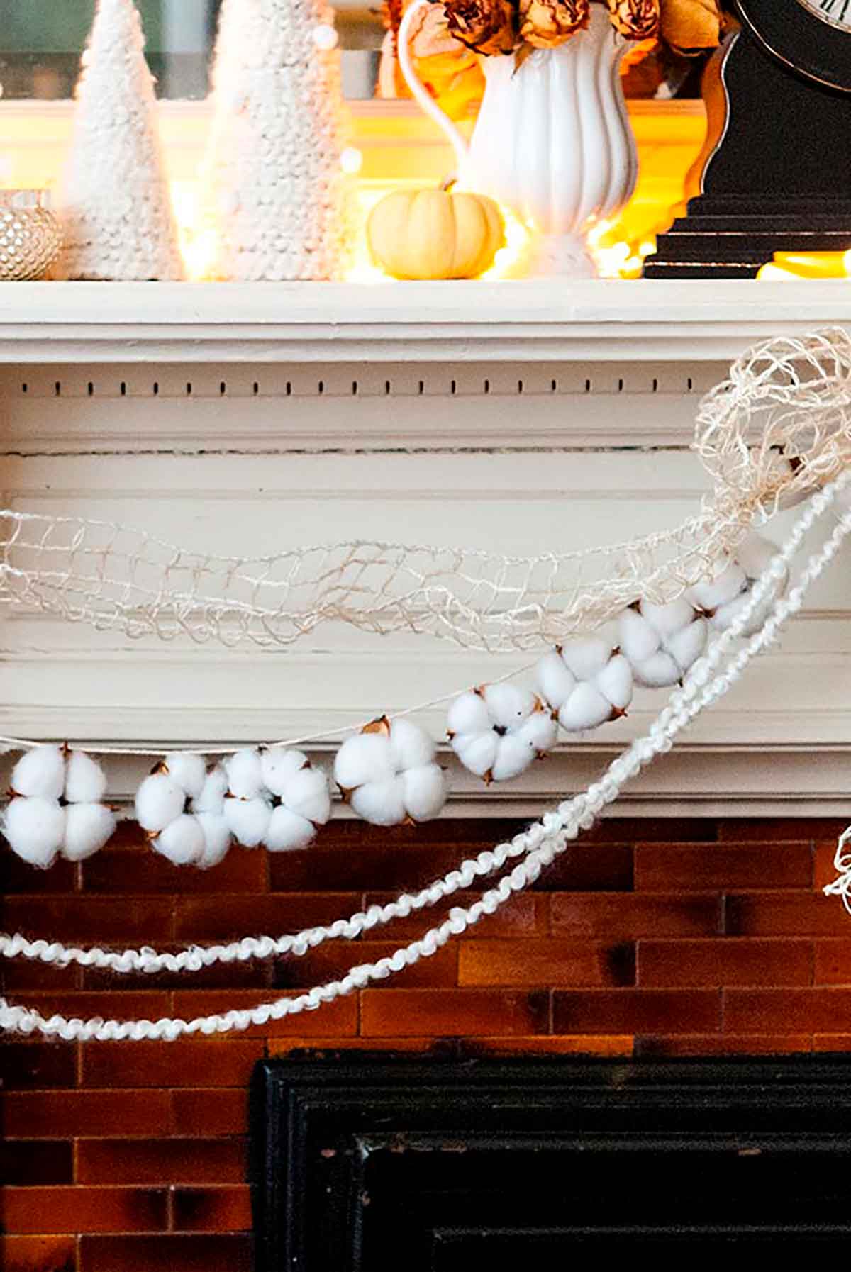 Cotton garland strung on a mantle with yarn and ribbon.