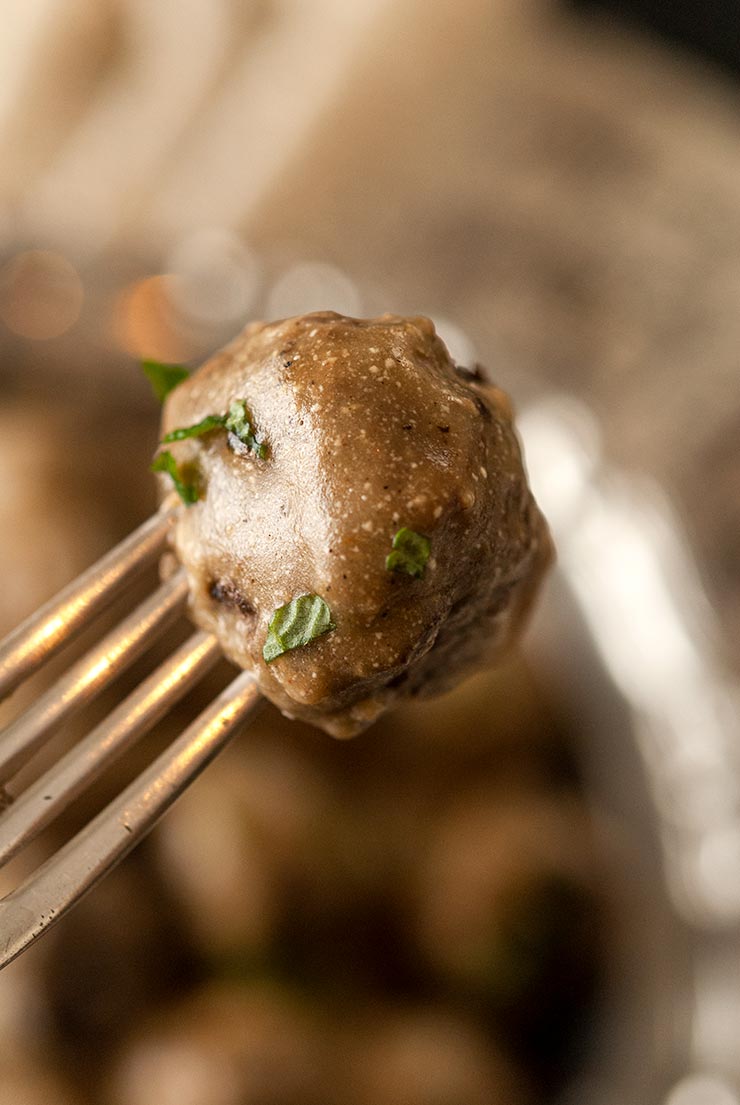 A fork holding a Swedish meatball. 