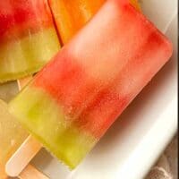 White Claw ice pops stacked on a white plate.