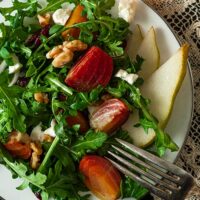 A beet and pear salad on a plate, on a lace table cloth.