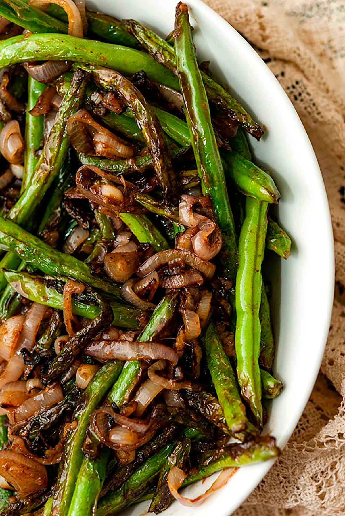 A bowl of blistered French green beens and shallots.