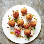 9 goat cheese croquettes on a plate.