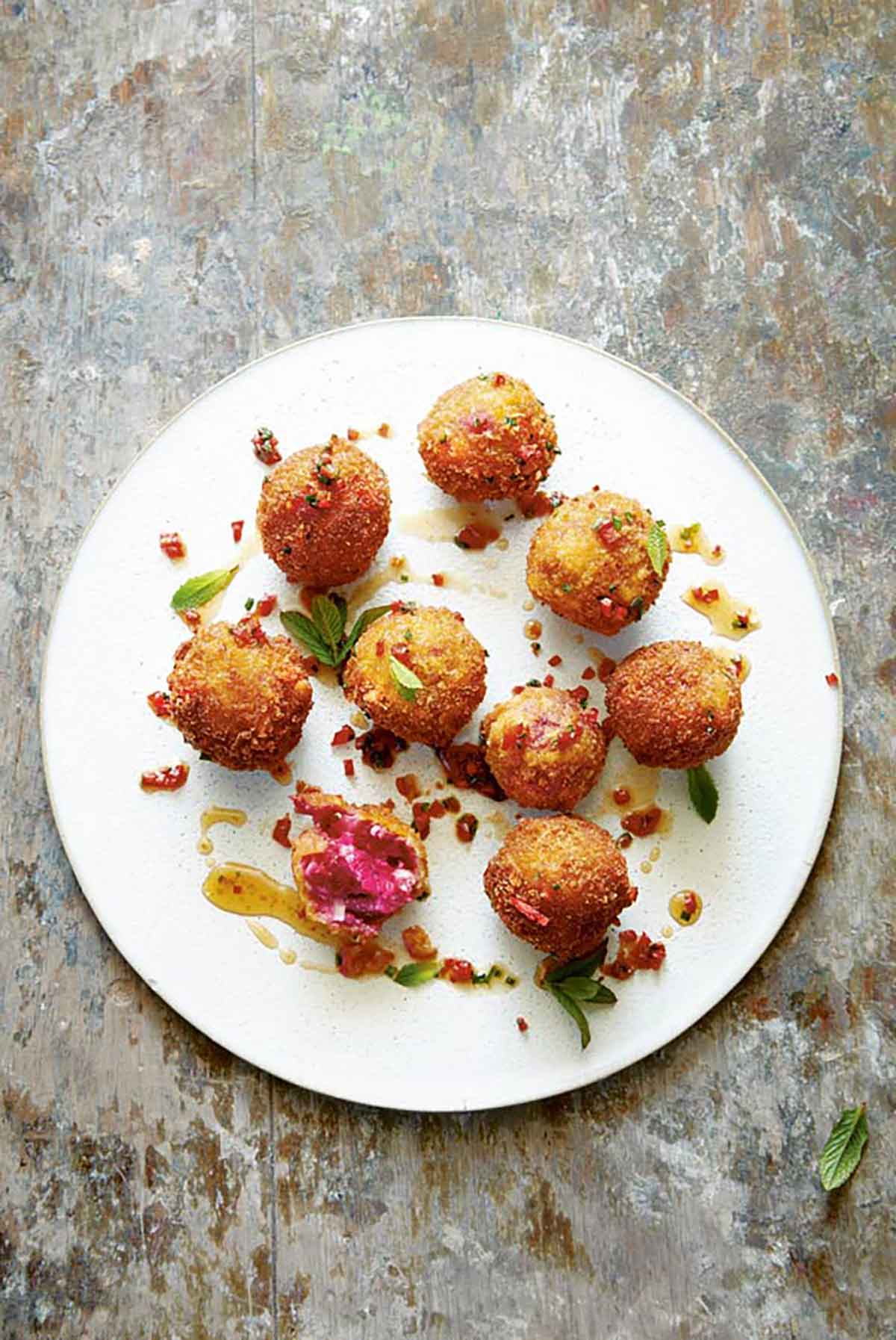 9 goat cheese croquettes on a plate.