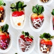 11 ornately decorated chocolate-covered strawberries.