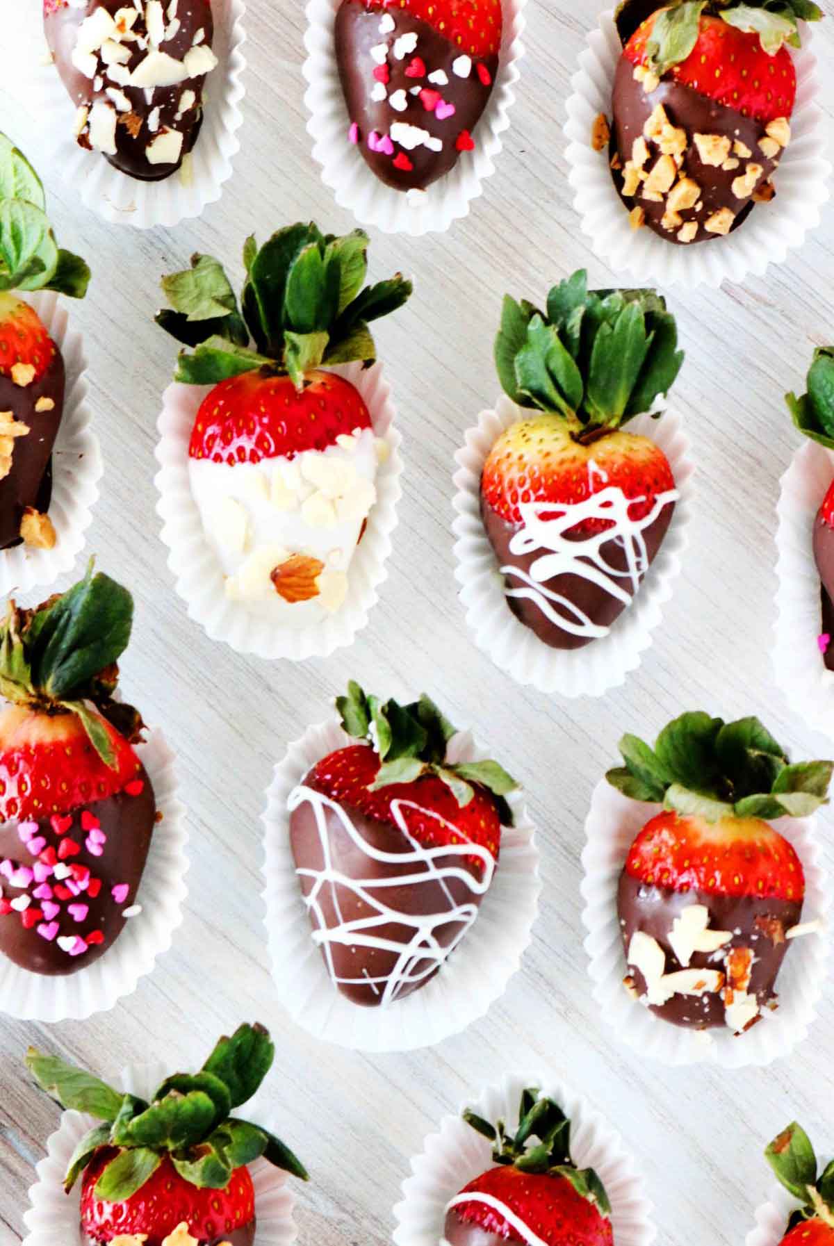 11 ornately decorated chocolate-covered strawberries.