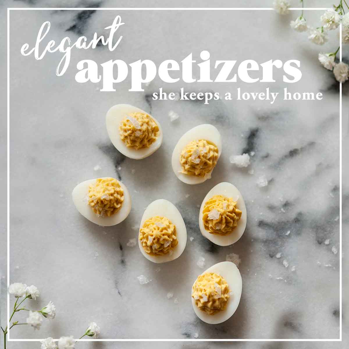 The cover of a cookbook that says "Elegant Appetizers” with deviled eggs on a marble background with flowers in the corners.