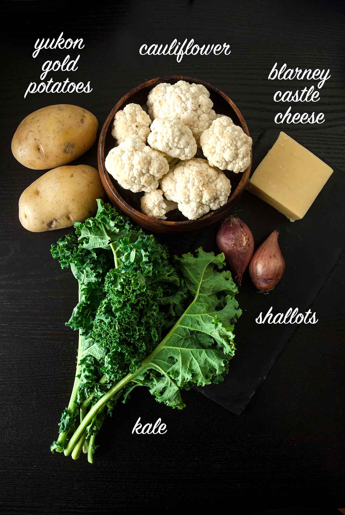 A group of ingredients on a black table with text labels.