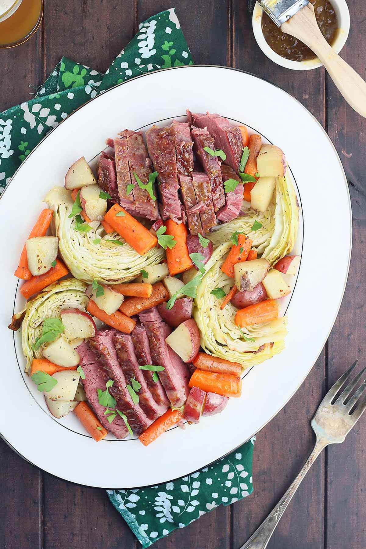 A large serving plate of corn beef and cabbage.