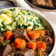 A bowl of Guinness beef stew with carrots.