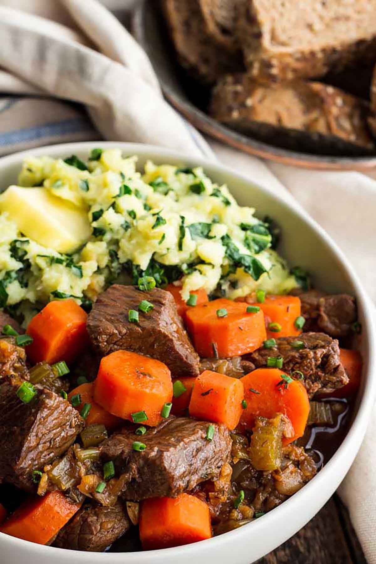 A bowl of Guinness beef stew with carrots.