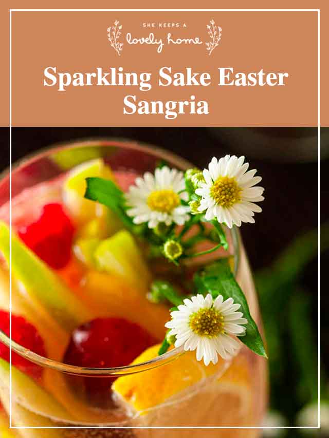 The daisy and fruit garnish in a glass of sake sangria.