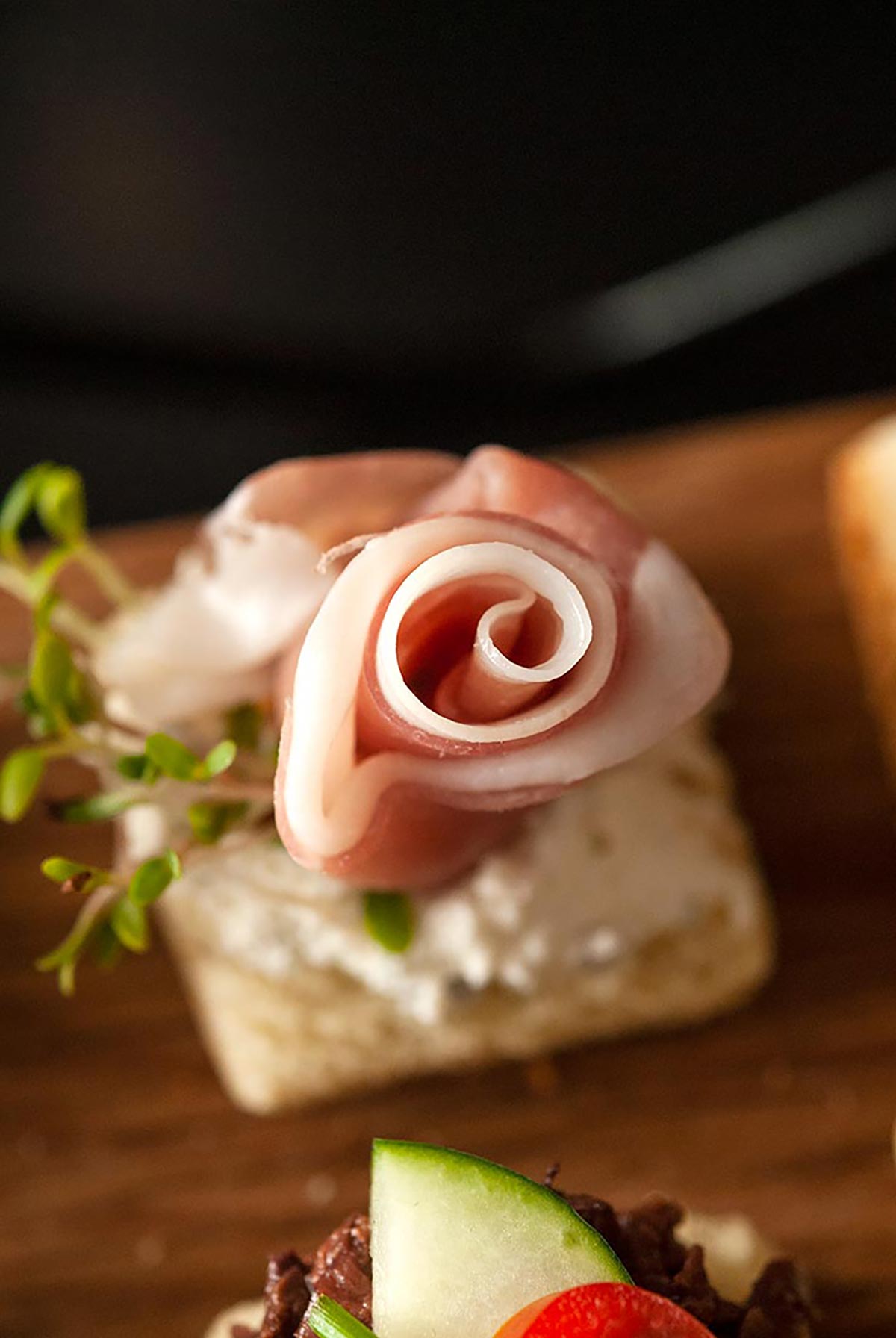 A canapé with a prosciutto rose.