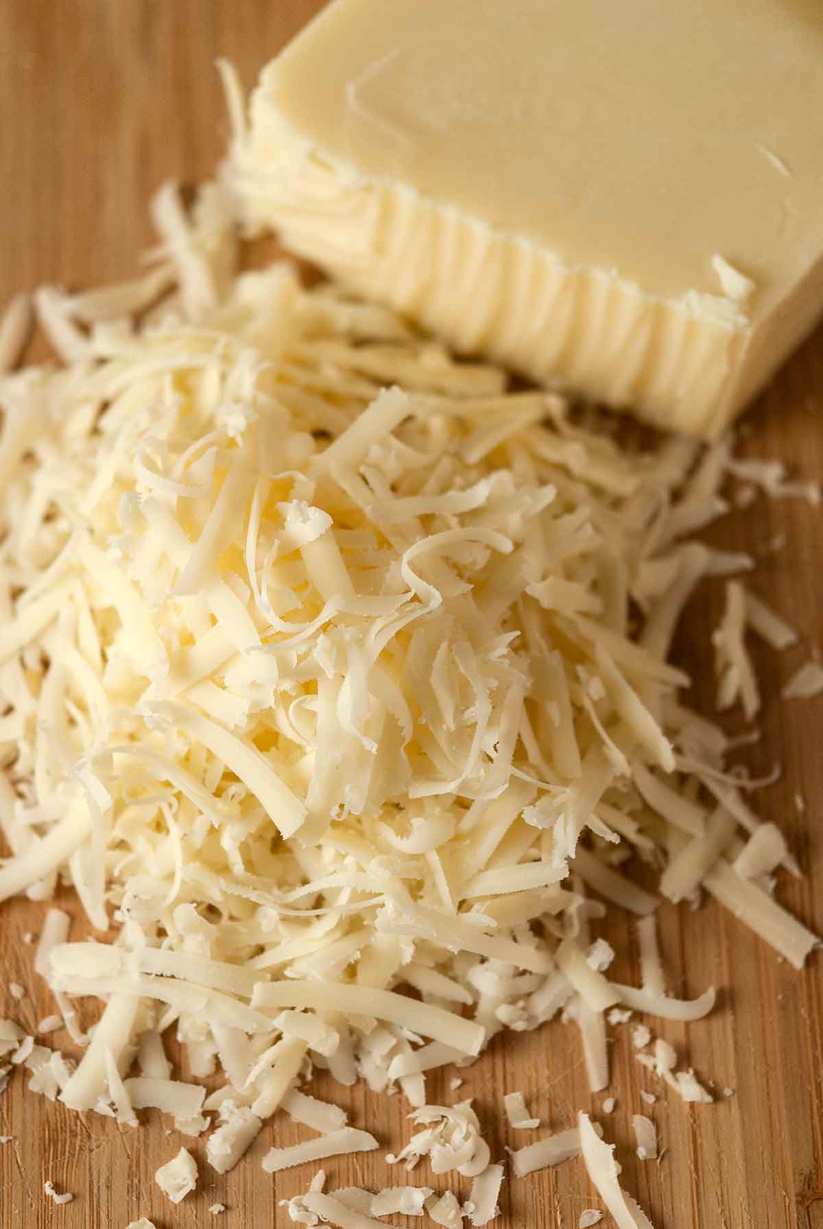 Grated cheese on a cutting board.