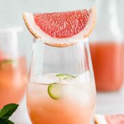 A grapefruit margarita with a slice of jalapeño inside and a slice of grapefruit on top.