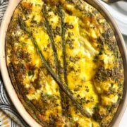 An asparagus frittata in a dish on a table.