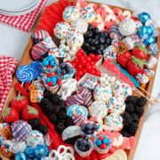 A try filled with red white and blue dessert treats on a table.