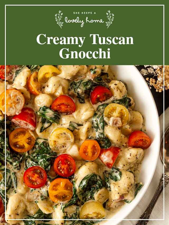 A bowl of colorful gnocchi with tomatoes in a bowl with a title that says “Creamy Tuscan Gnocchi.”