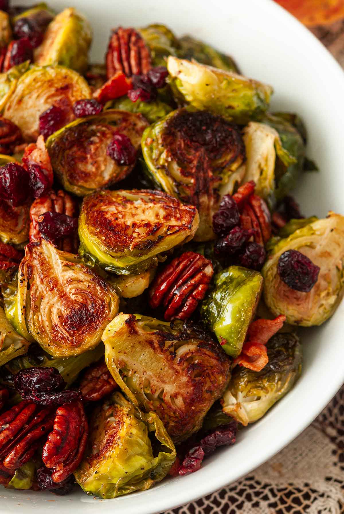 A bowl of Brussels sprouts, bacon, cranberries and pecans.