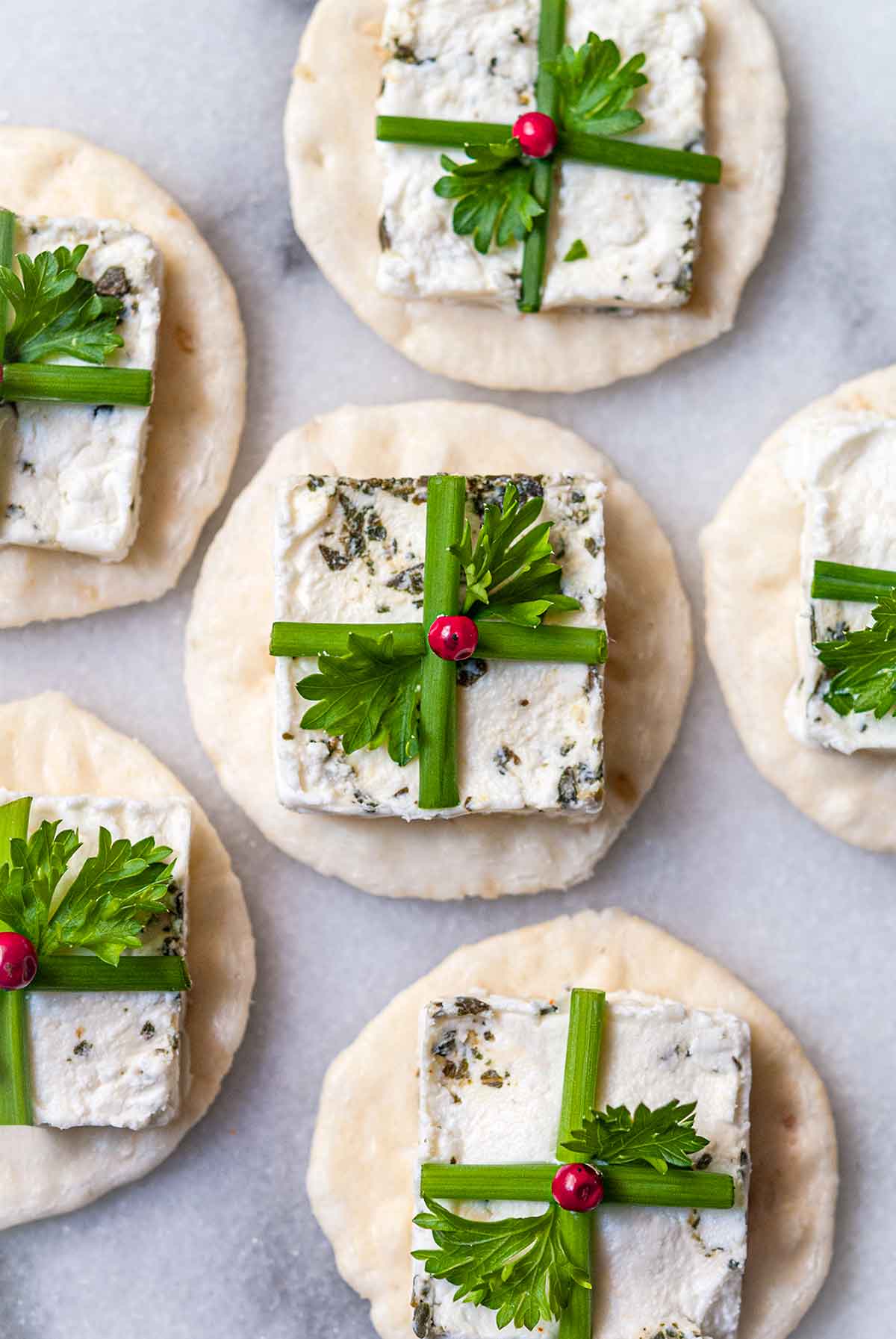 6 goat cheese appetizers on marble that look like presents.