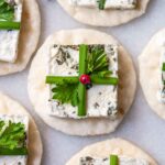 A goat cheese appetizer on marble that looks like a present.