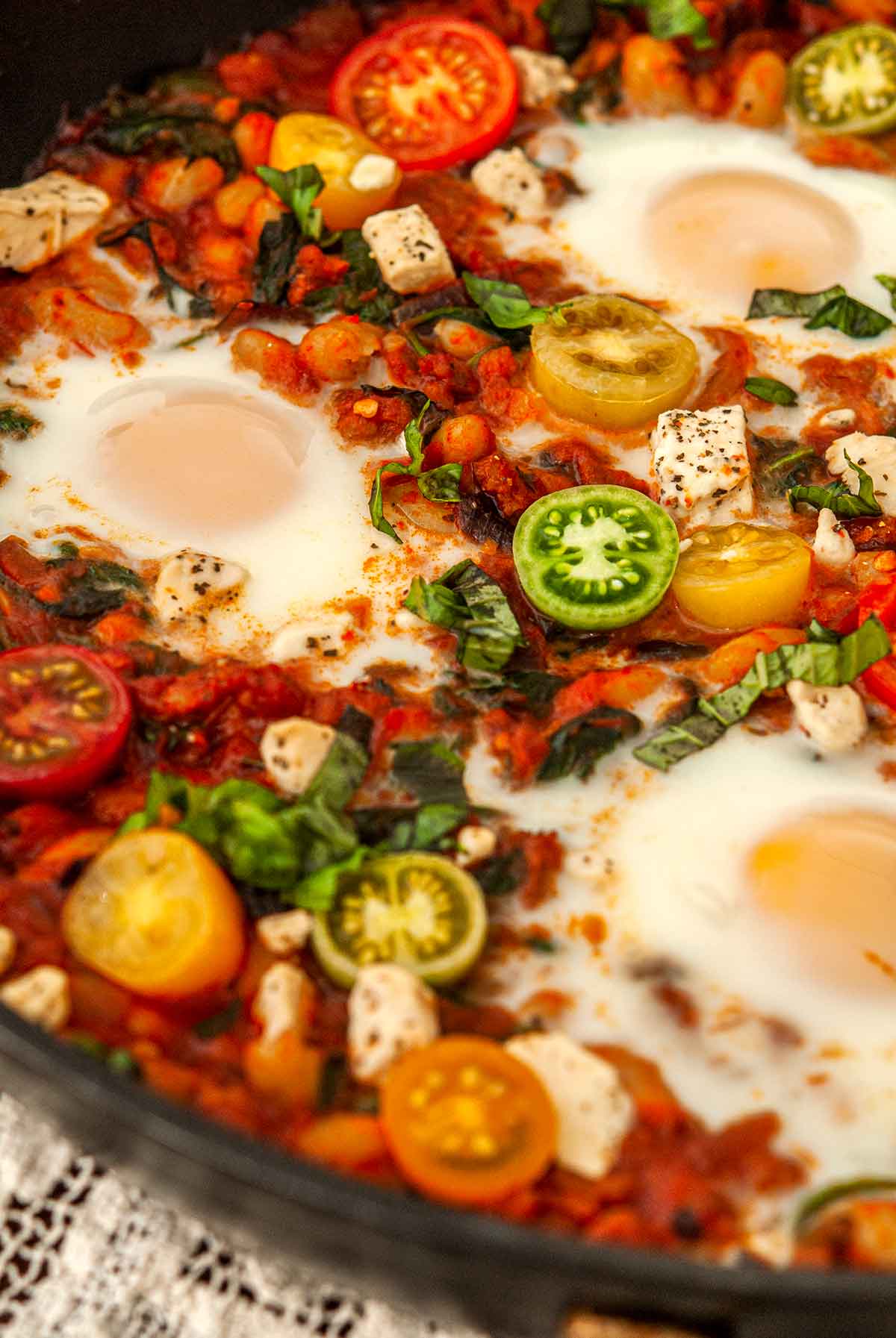 The cherry tomatoes on Italian Eggs in Purgatory in a pan.