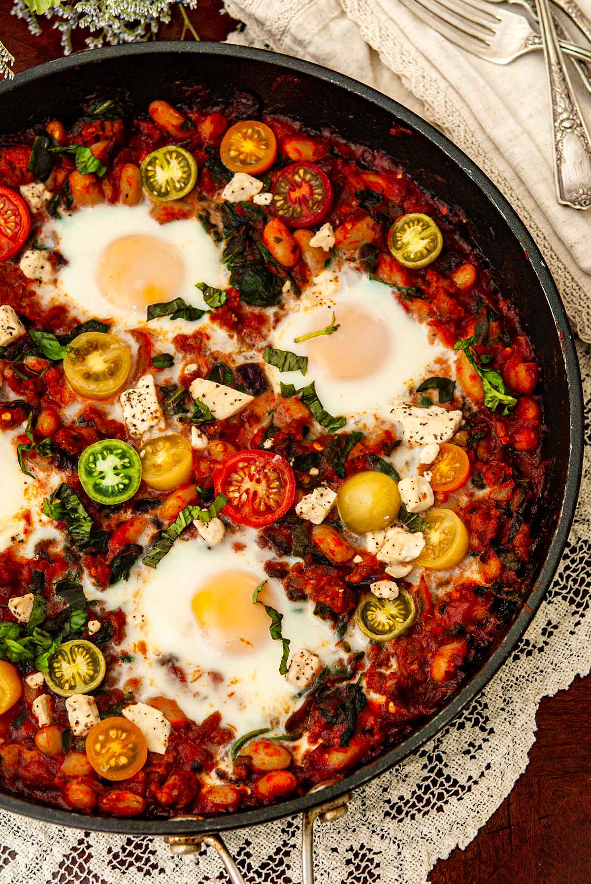 Italian Eggs in Purgatory in a pan on a tablecloth.