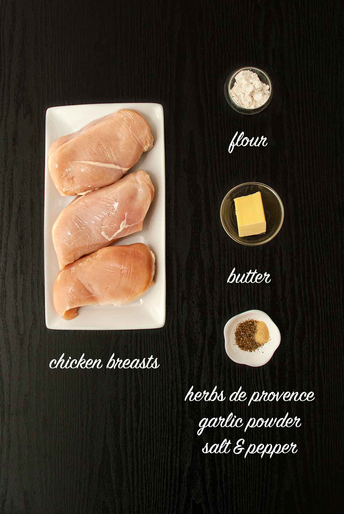 4 ingredients on table that make chicken with Herbs de Provence.