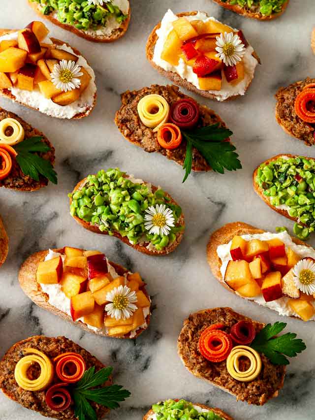 Garnished crostini on marble.