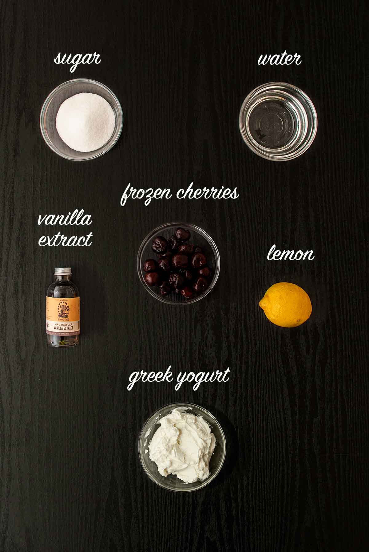 6 ingredients on a table for making yogurt with cherry spoon sweets.
