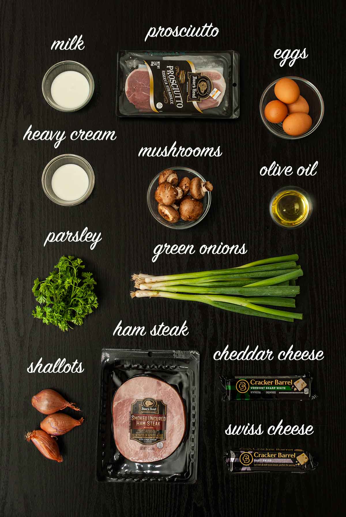 12 labeled ingredients for making ham and mushroom quiche on a table.