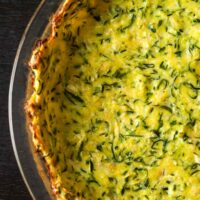 Baked zucchini crust in a pyrex dish.