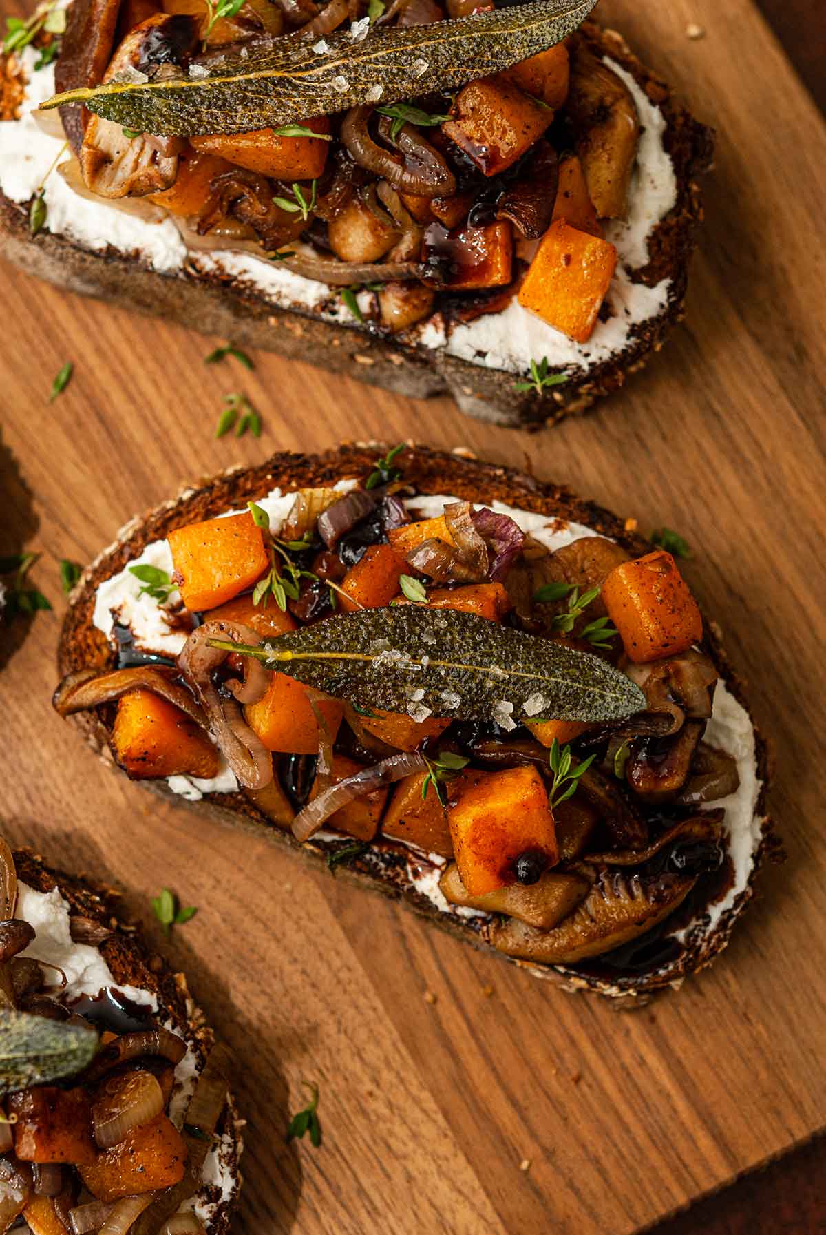 3 maple butternut squash crostini on a wooden board.