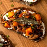 1 maple butternut squash crostini on a wooden board.