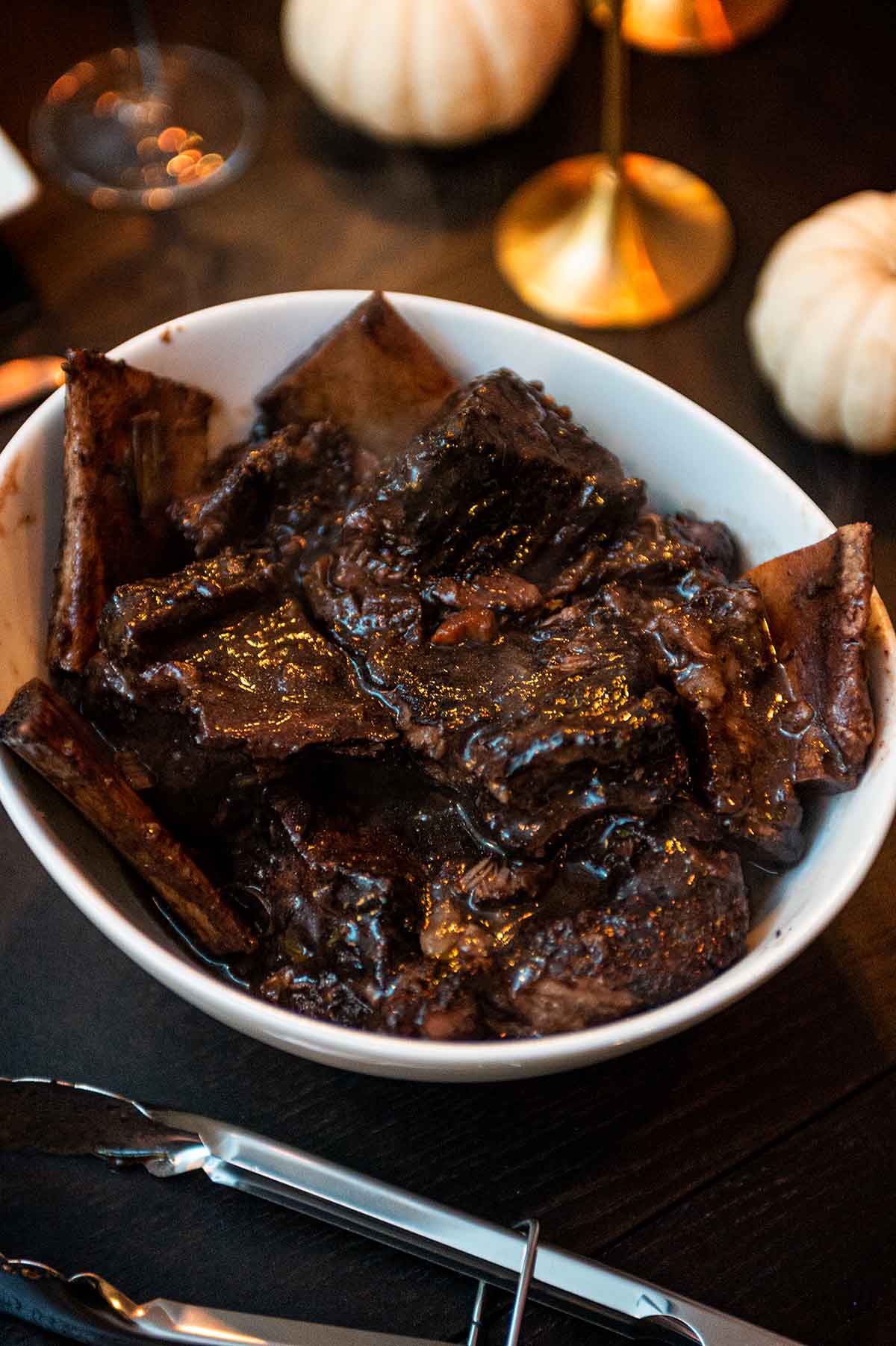 A bowl of braised short ribs on a table.