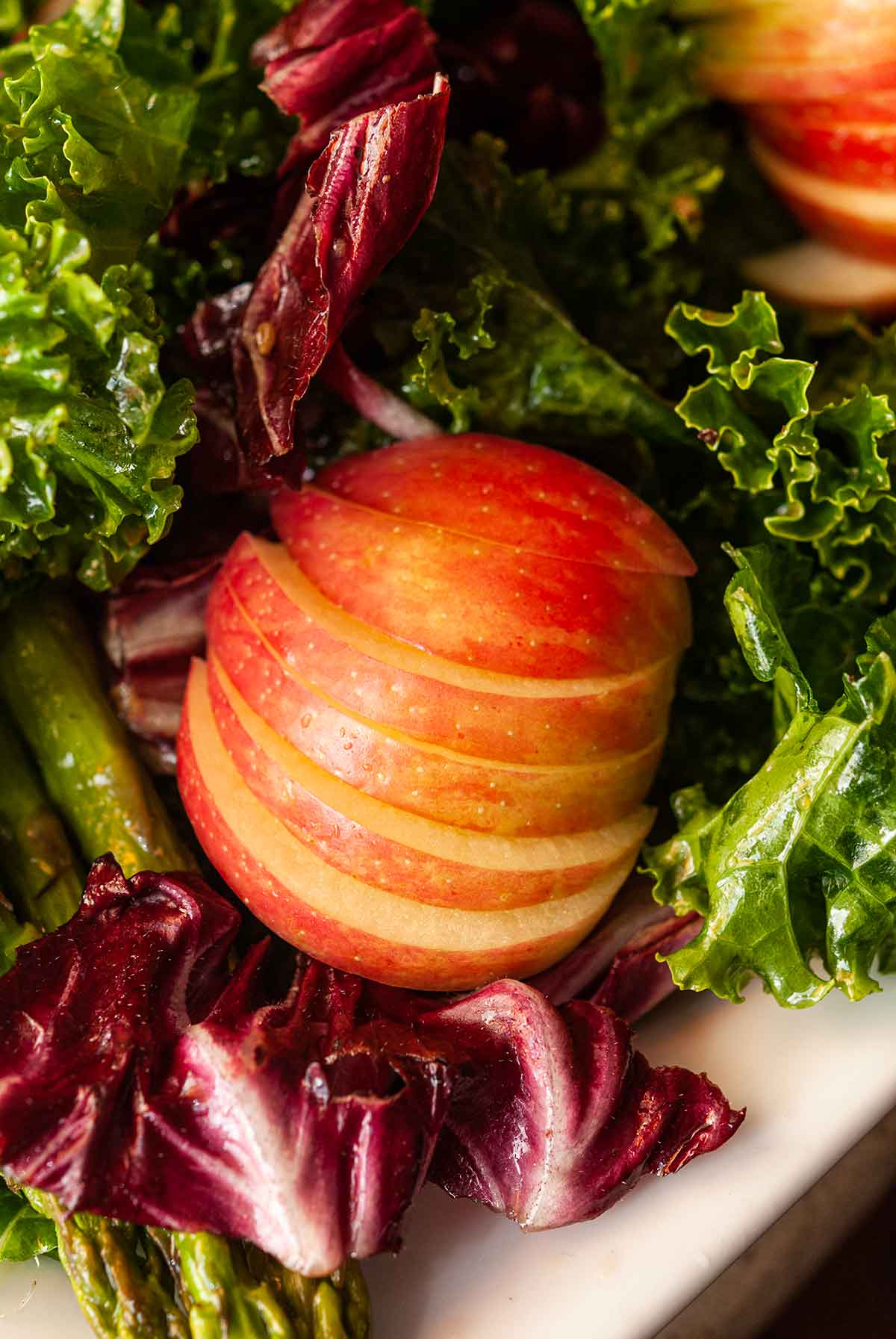 A fanned sliced apple in a salad.