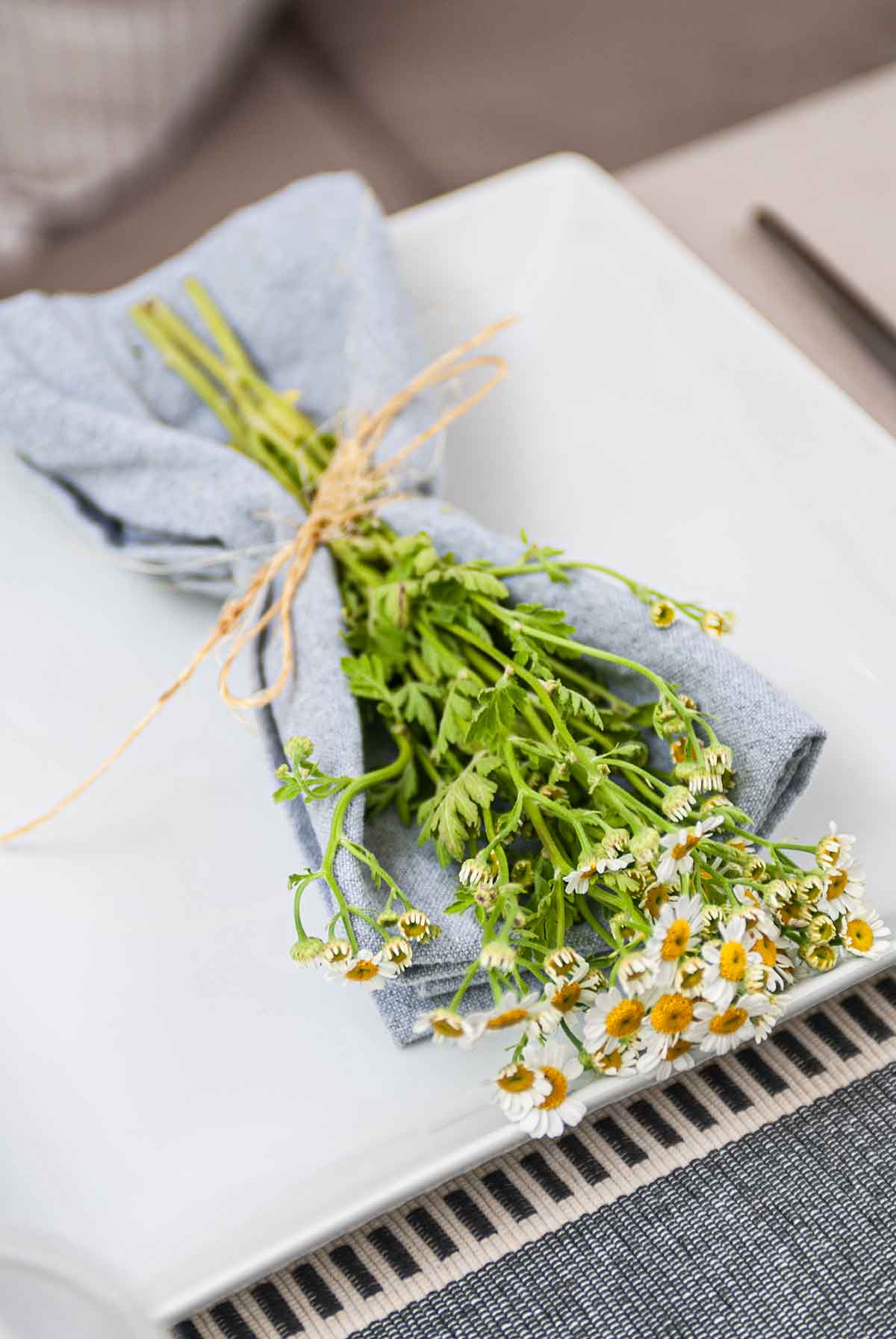 Camomile flowers in a bouquet on a plate.