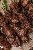 Lamb skewers on a rustic platter.